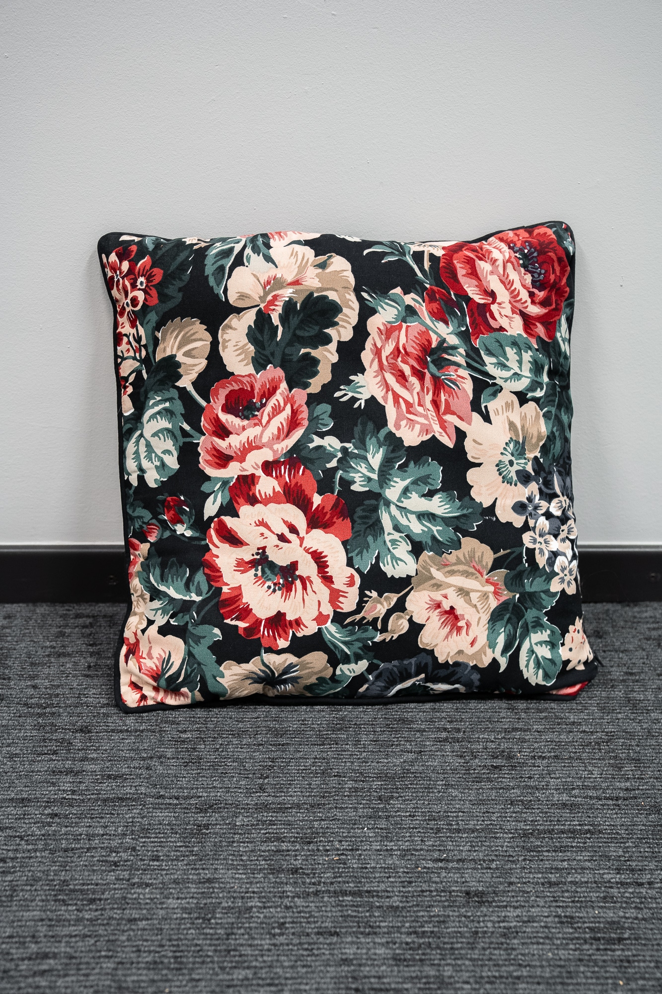  black cushion with floral motifs