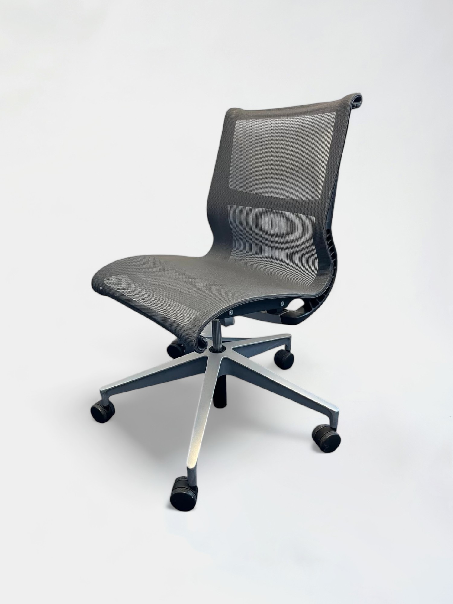 Herman Miller Setu mesh dark grey office chair without armrests on wheels