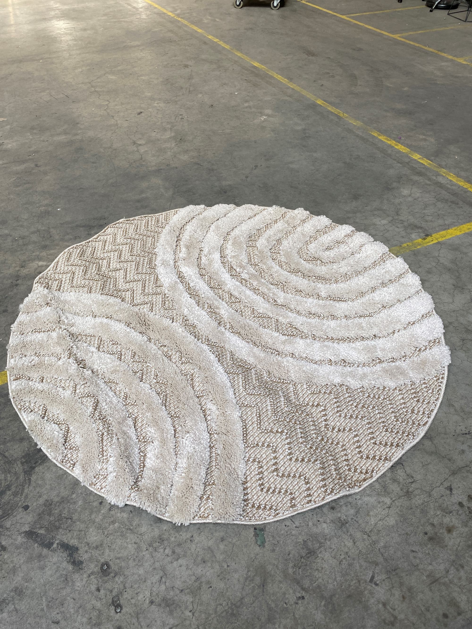 Beige fabric round rug with textured pattern