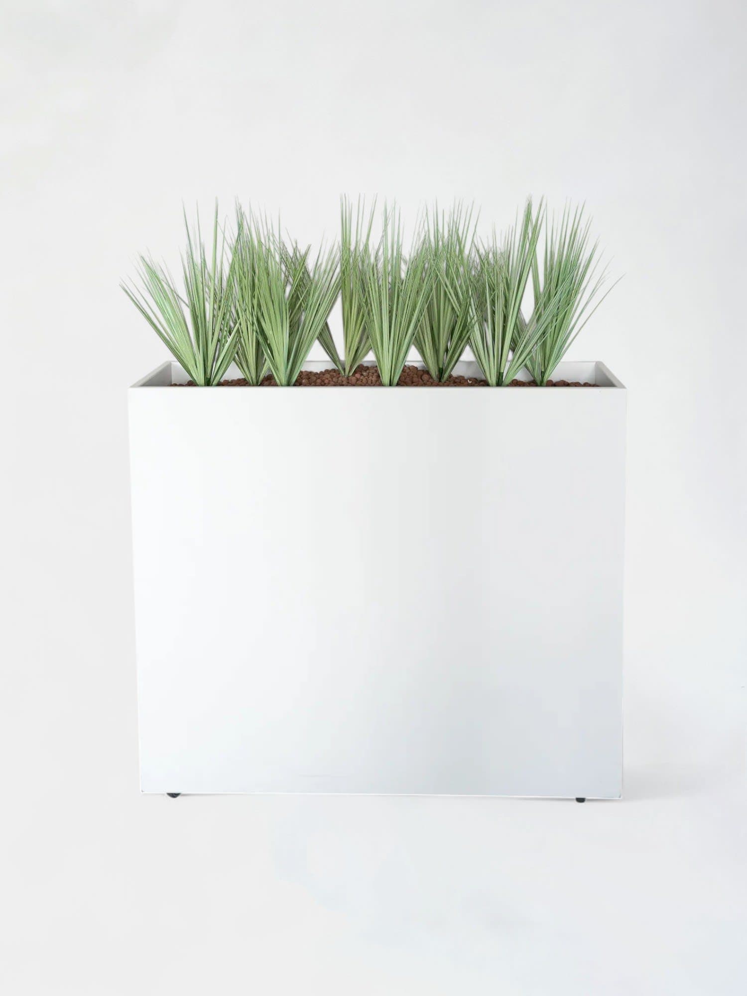 White planter with fake plants on wheels
