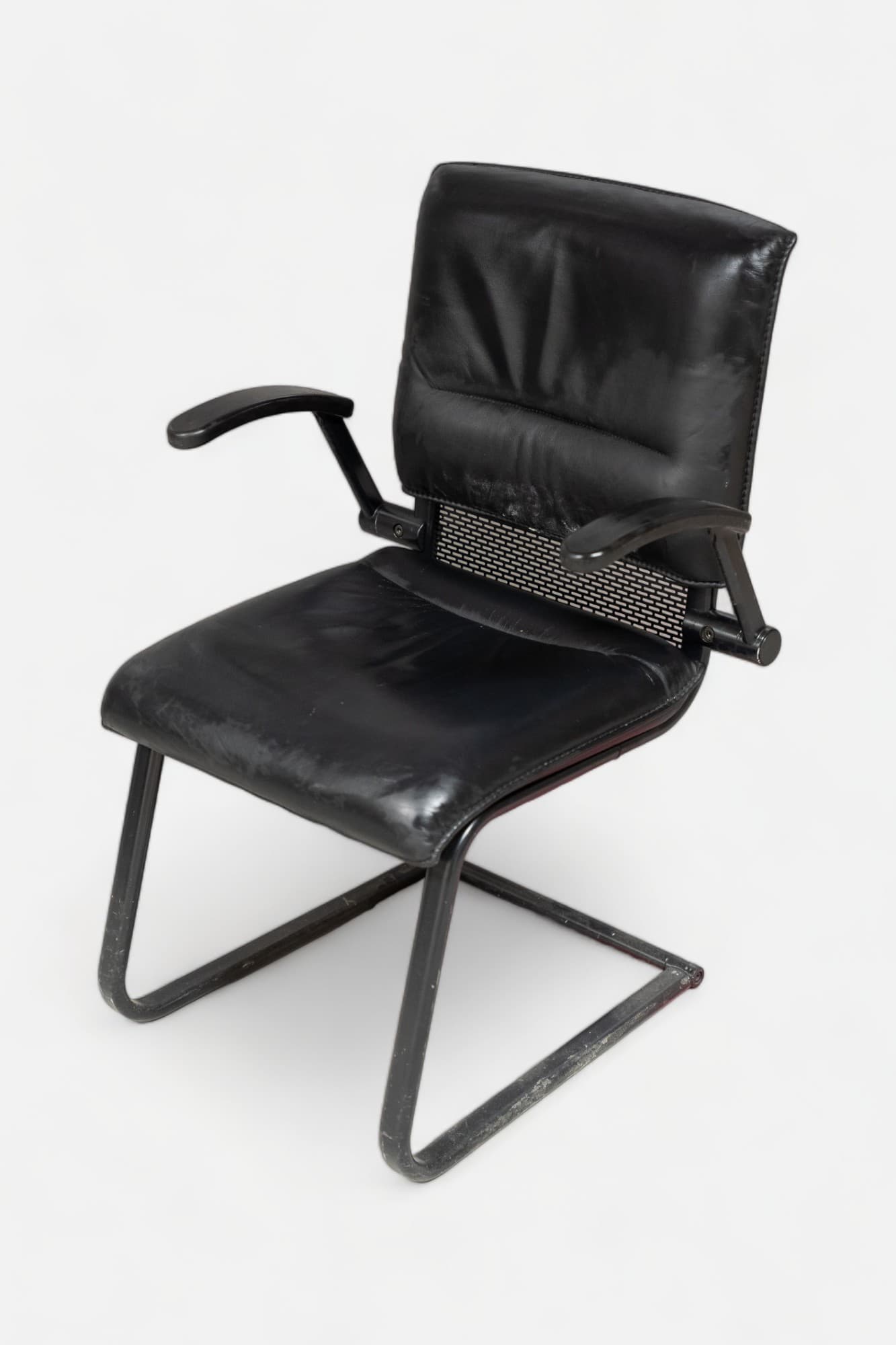 Black leather chair on black legs