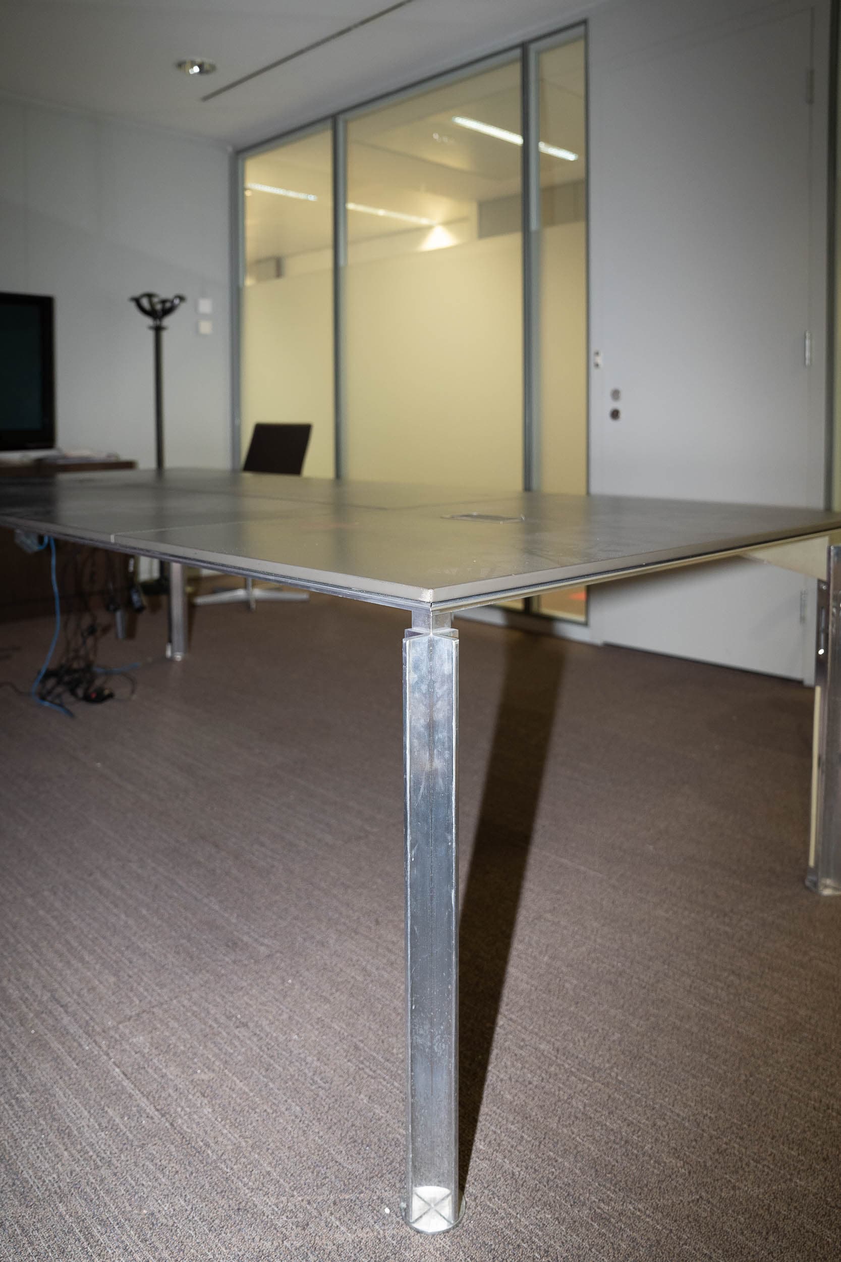 Bulo meeting table with leather top and top access on chromed legs
