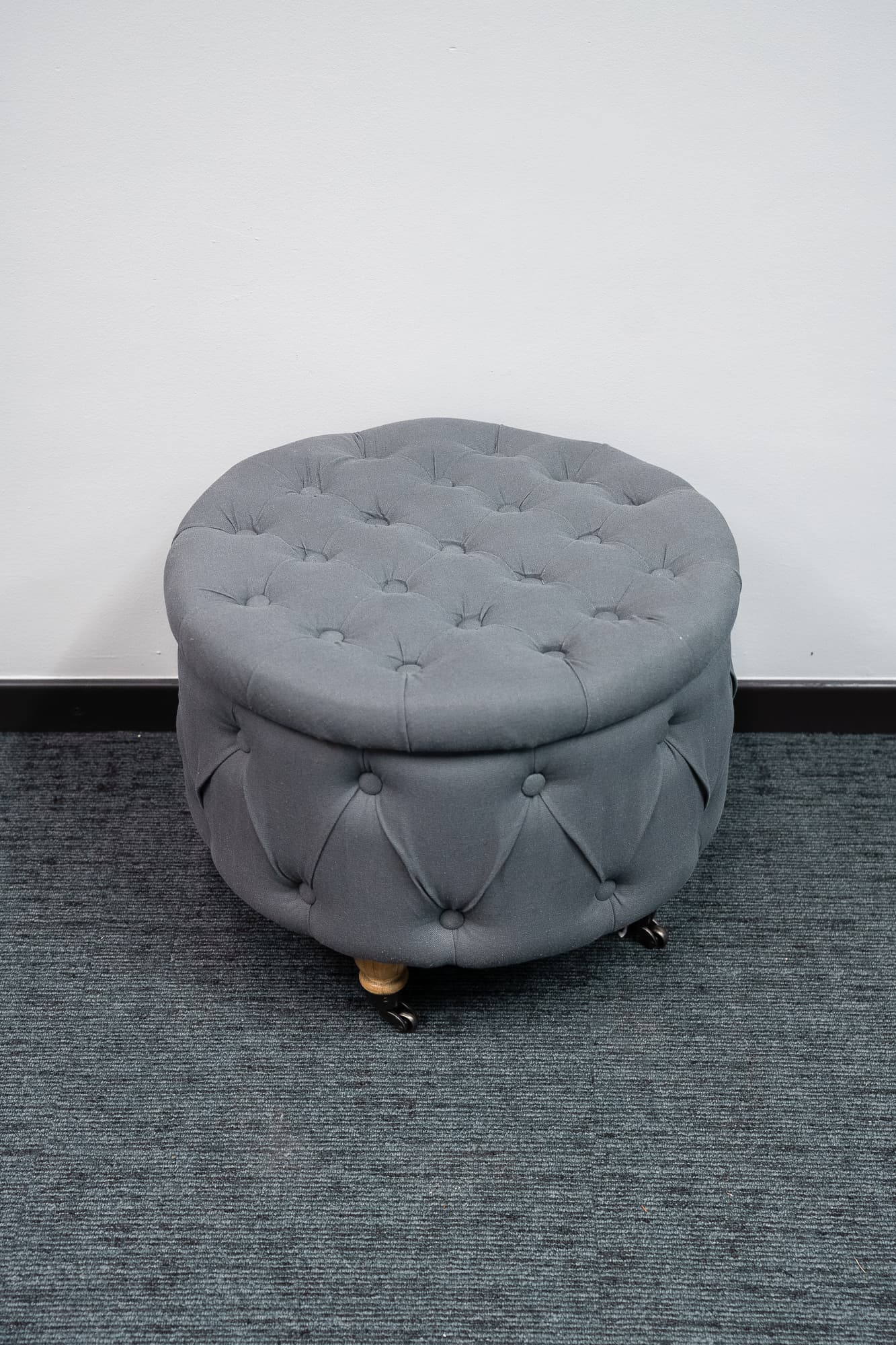 Charming blue-gray velvet pouffe on castors