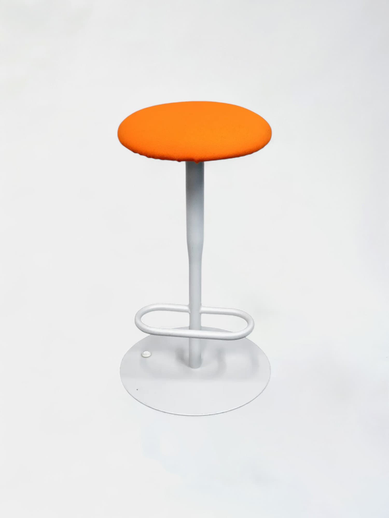 Orange rounded high stool on white legs