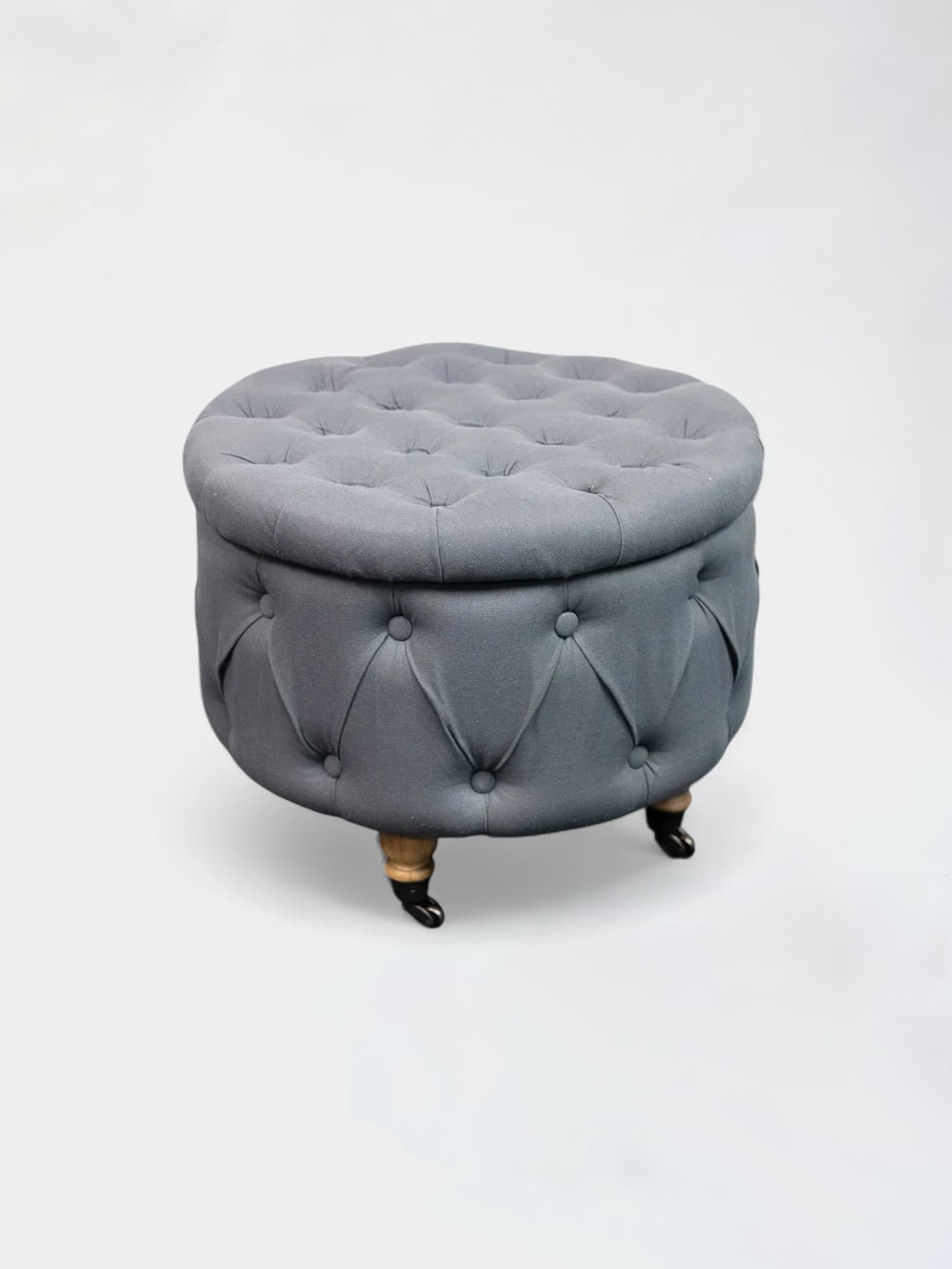Charmant pouf en velours bleu-gris sur roulettes