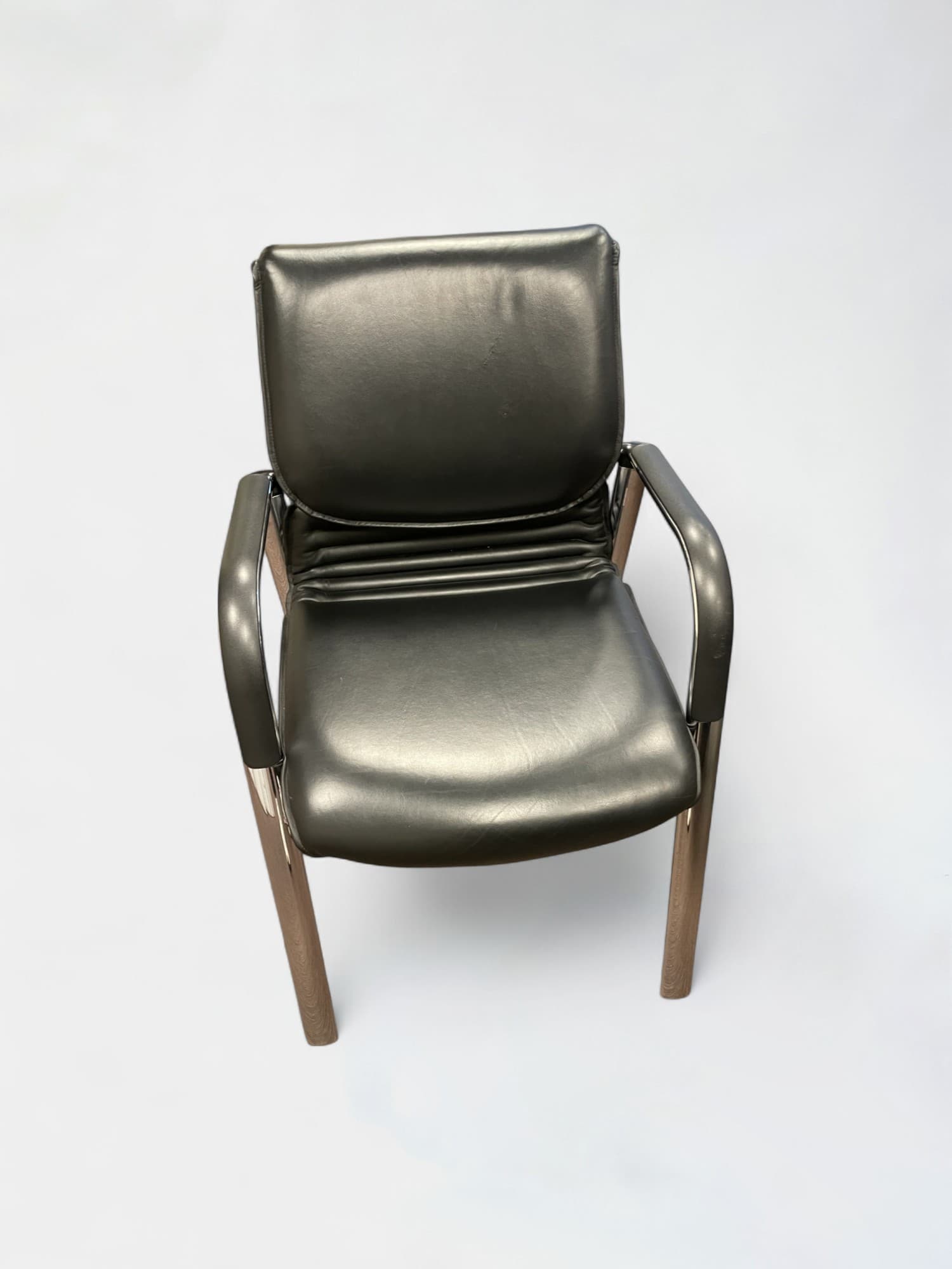 Comforto black leather chair on steel legs