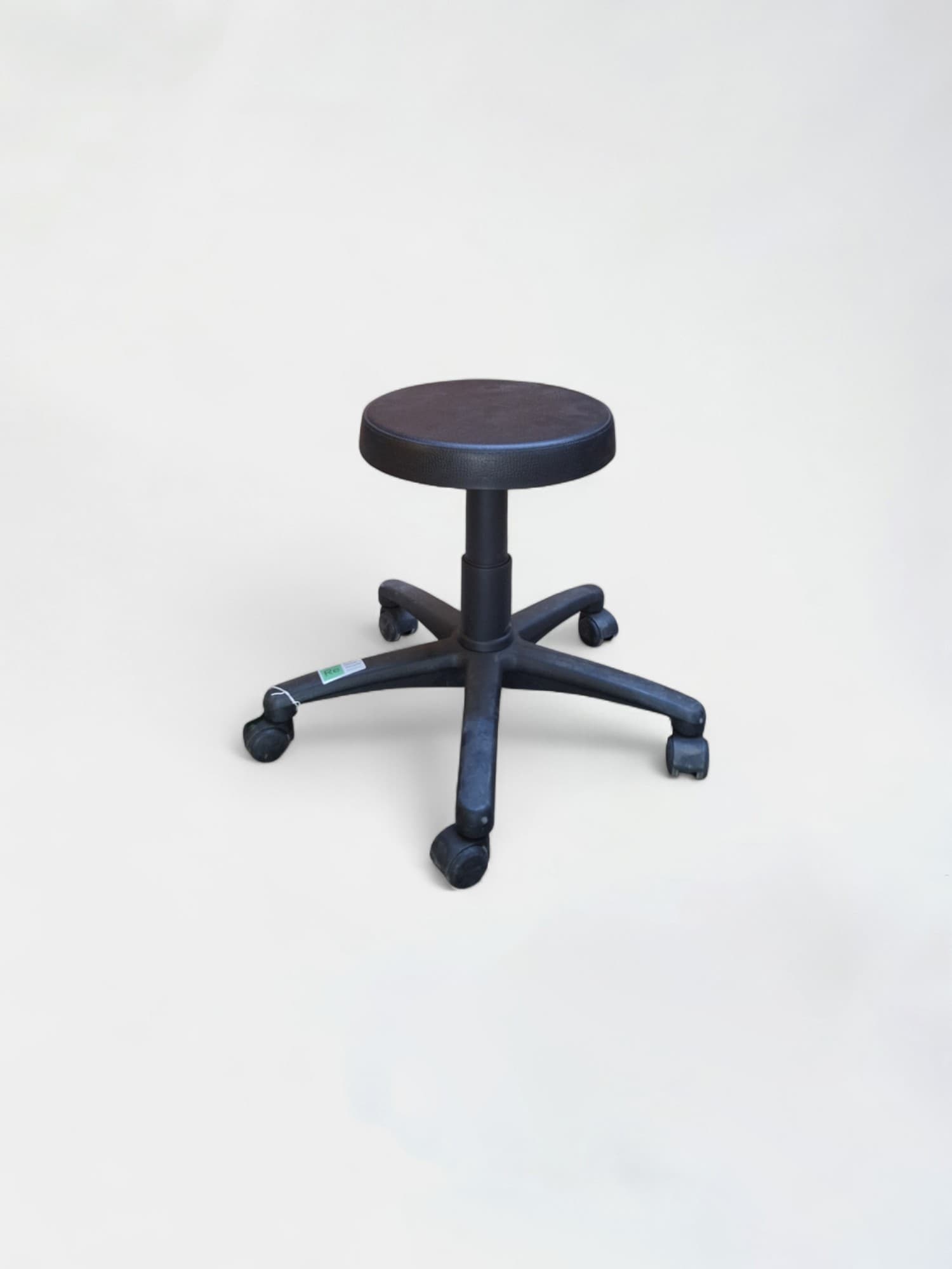 Low black stool on wheels
