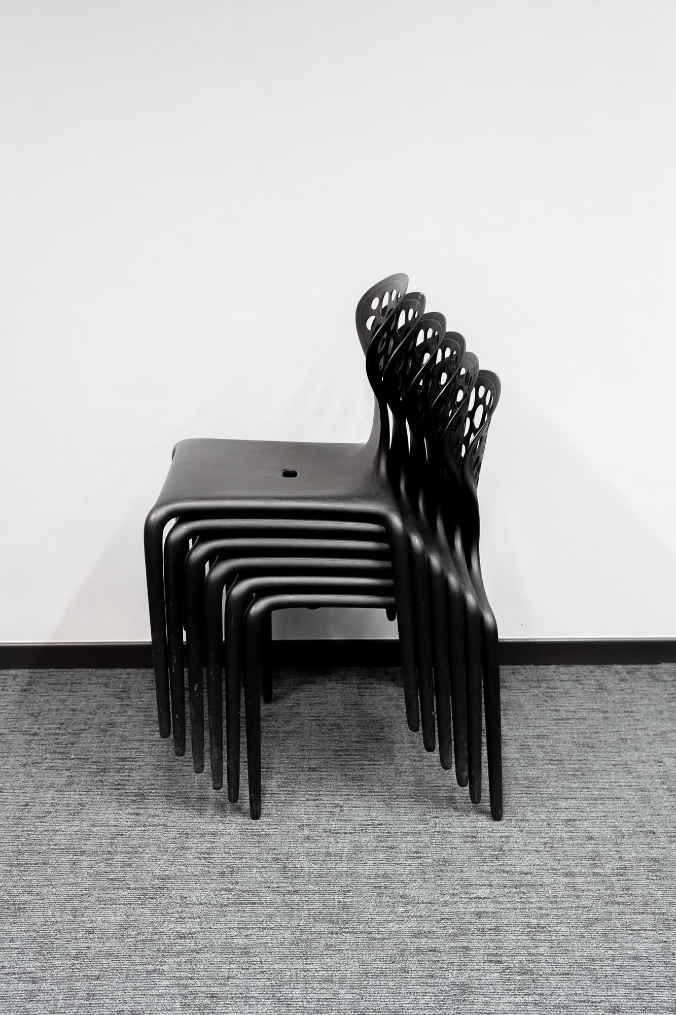 Moroso Supernatural black stackable design chairs by Ross Lovegrove