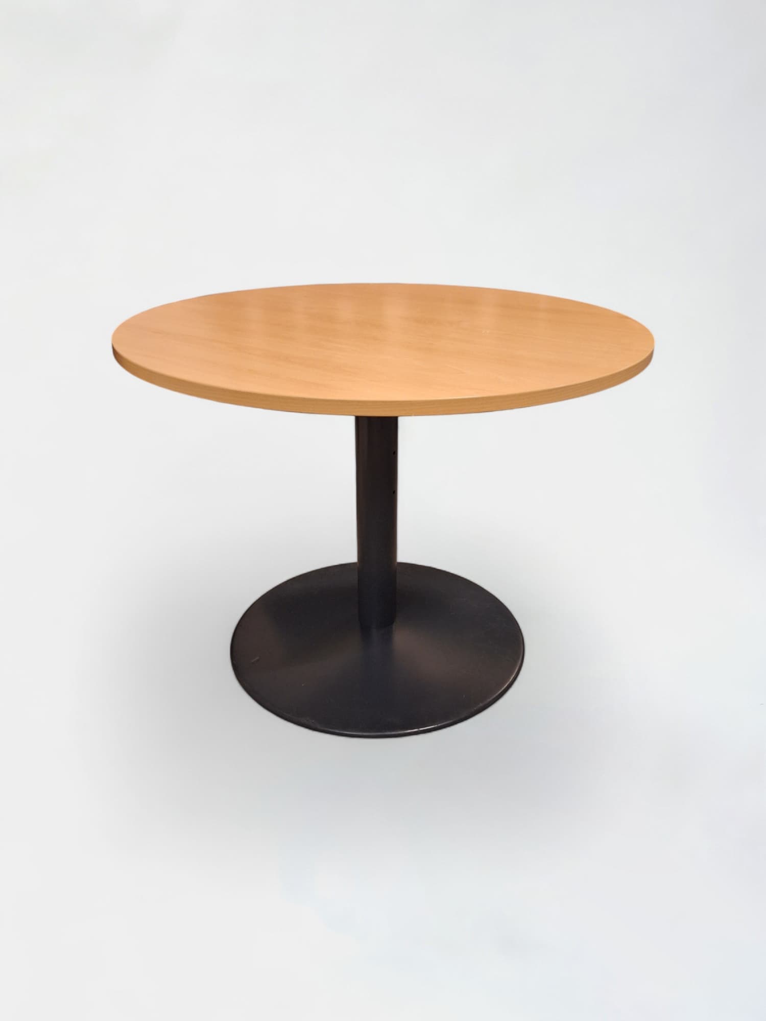 Laminate wooden rond table with black leg and small damage on the top