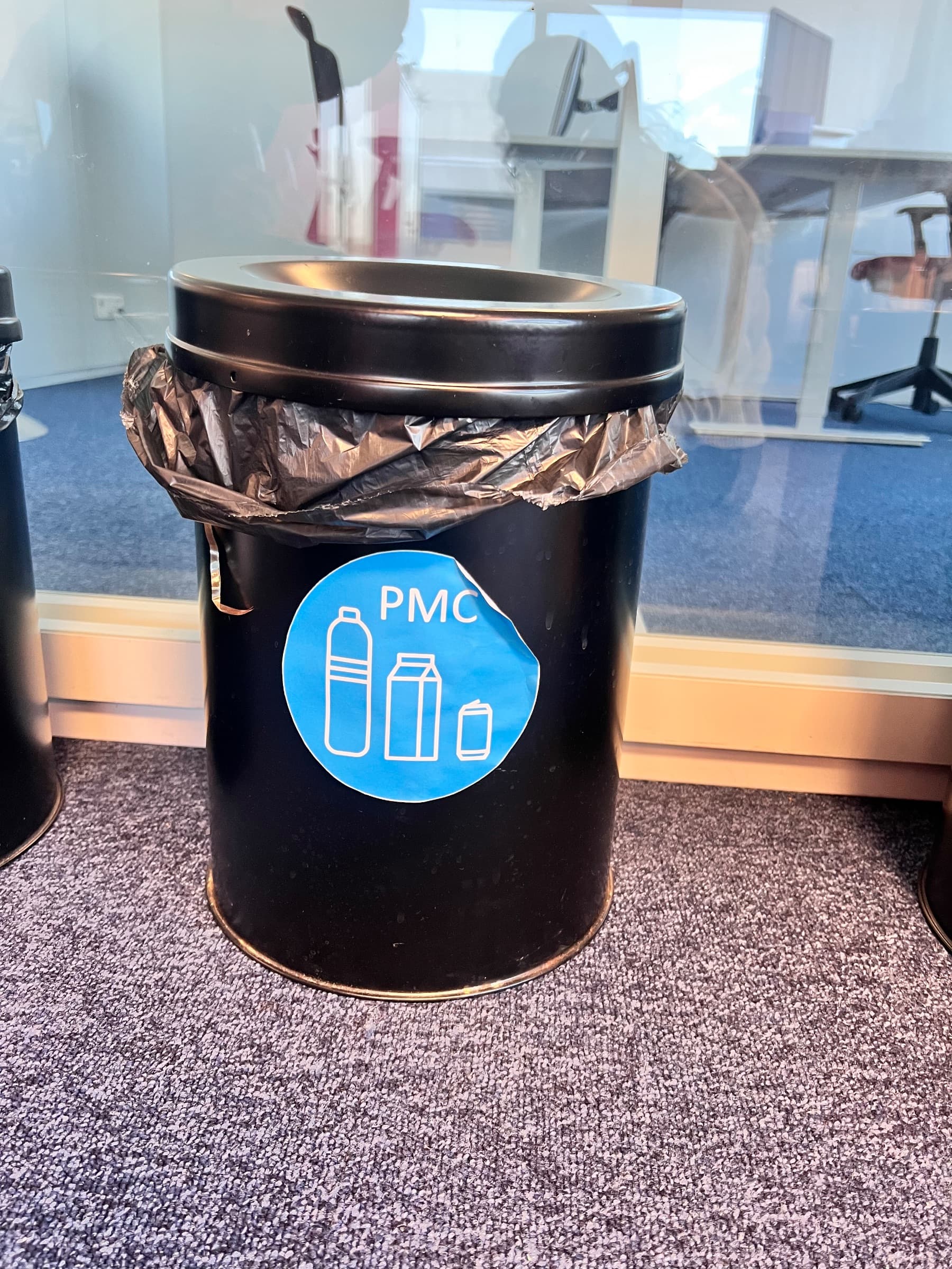 Black metal waste bin