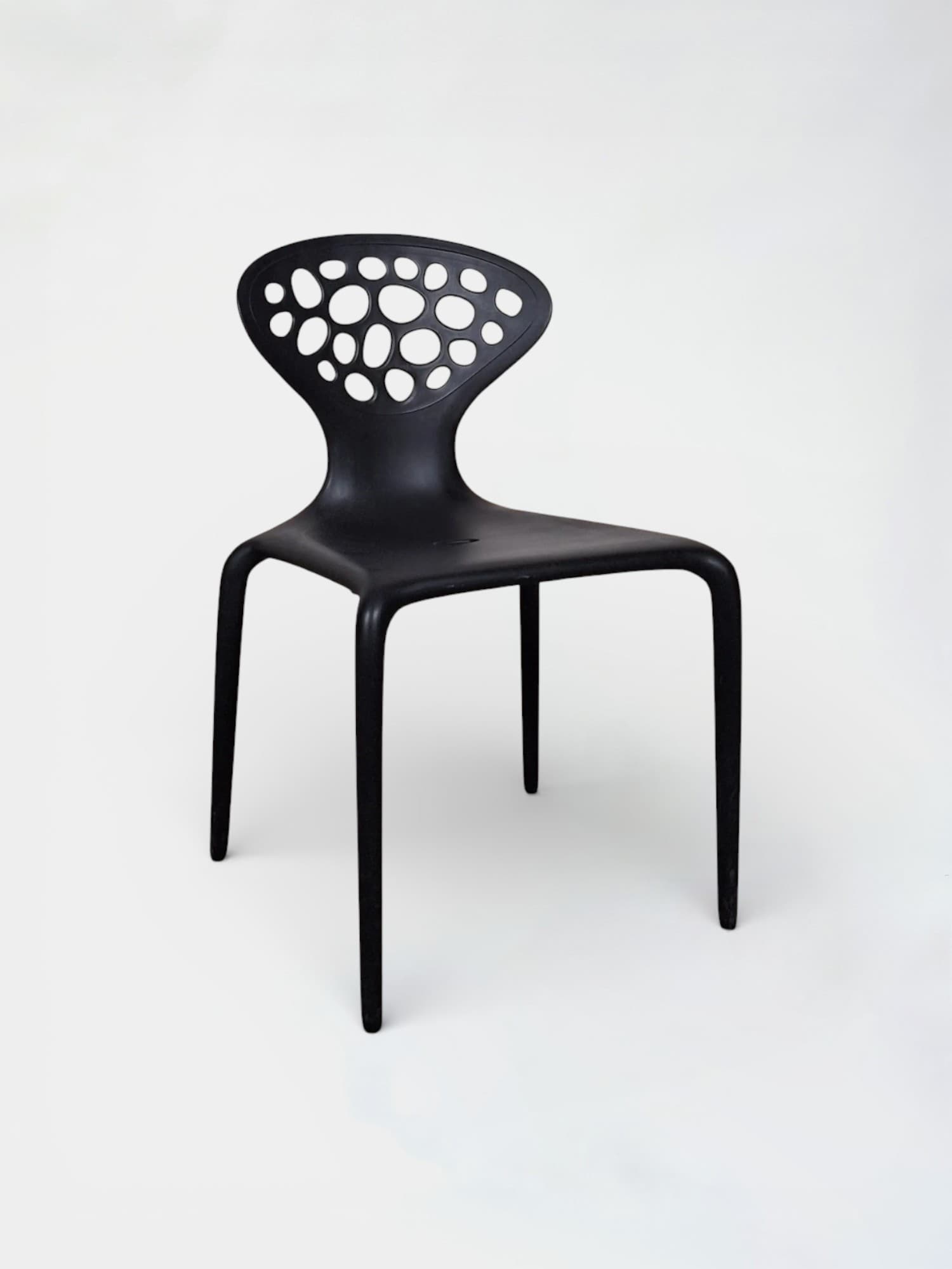 Moroso Supernatural black stackable design chairs by Ross Lovegrove