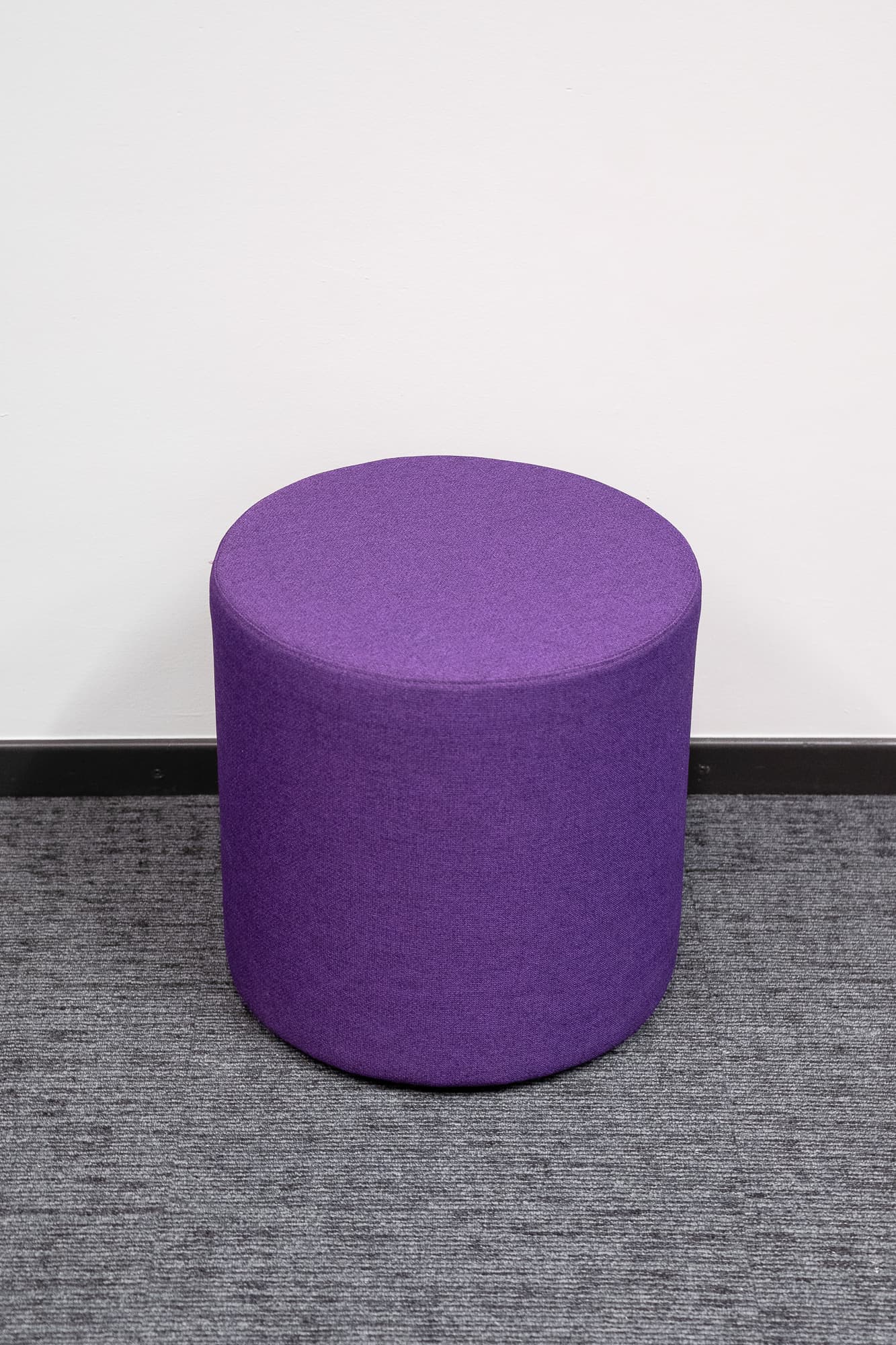 Round dark mauve pouffe