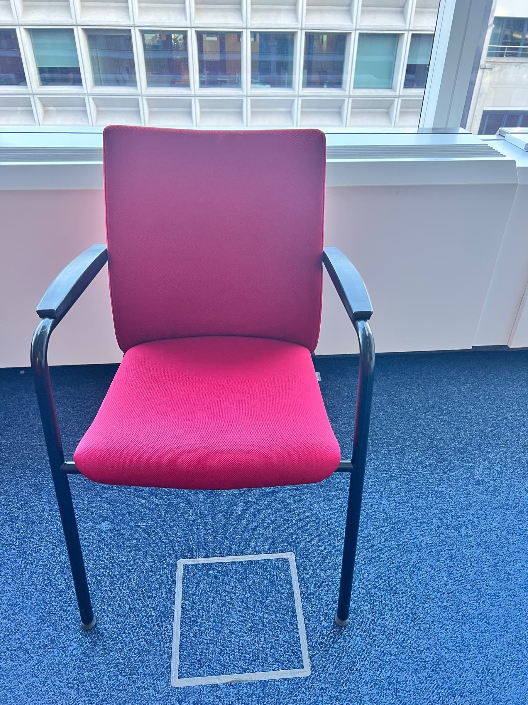 Red fabric office chair with armrests